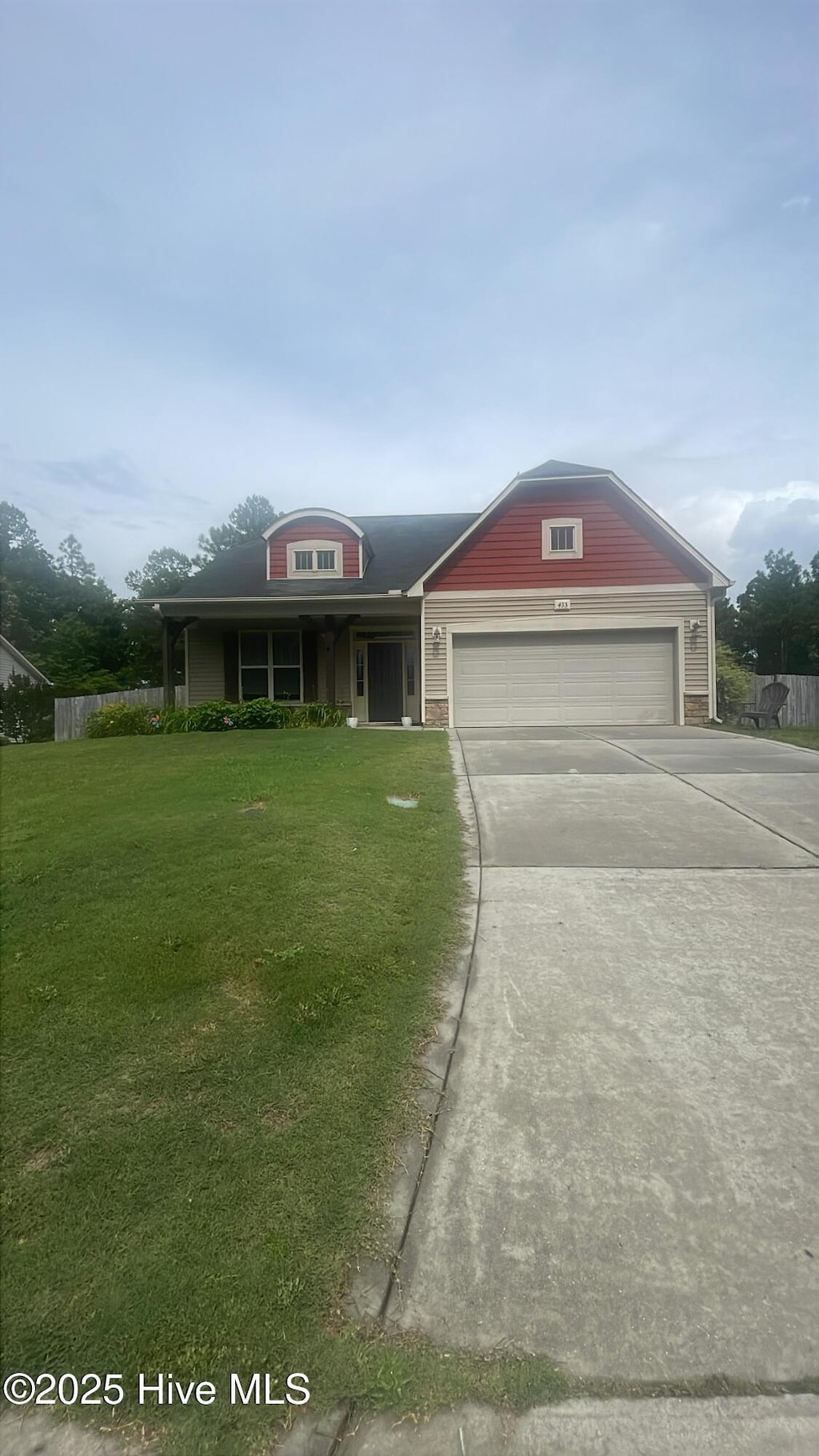 433 Shepherd Trl, Aberdeen, NC 28315 - view of front facade with an attached garage, a front yard, concrete driveway, and covered porch
