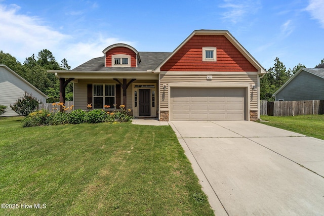 433 Shepherd Trl, Aberdeen, NC 28315 - view of front of home with covered porch, concrete driveway, a garage, and stone siding