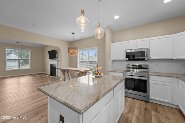 433 Shepherd Trl, Aberdeen, NC 28315 - kitchen featuring appliances with stainless steel finishes, decorative backsplash, a fireplace, open floor plan, and recessed lighting