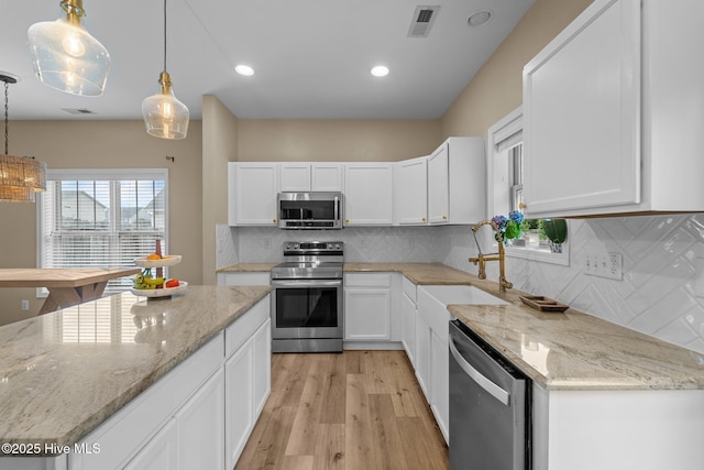 433 Shepherd Trl, Aberdeen, NC 28315 - kitchen with appliances with stainless steel finishes, white cabinetry, light wood-style flooring, and recessed lighting