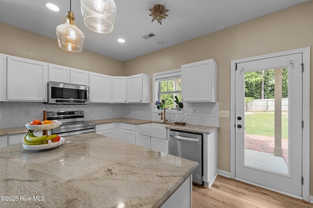 433 Shepherd Trl, Aberdeen, NC 28315 - kitchen featuring stainless steel appliances, white cabinetry, light stone countertops, and recessed lighting