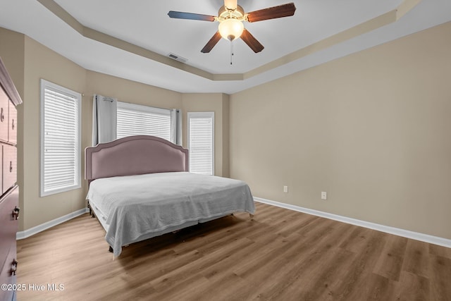 433 Shepherd Trl, Aberdeen, NC 28315 - bedroom with a raised ceiling, light wood-style floors, and ceiling fan