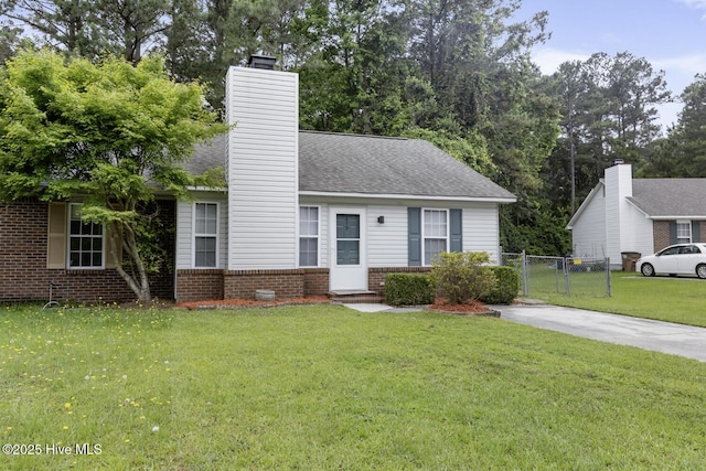 219 Live Oak Ct, Midway Park, NC 28544 - view of front of home with brick siding, a chimney, and roof with shingles