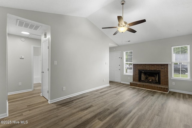 219 Live Oak Ct, Midway Park, NC 28544 - unfurnished living room featuring wood finished floors, lofted ceiling, ceiling fan, baseboards, and a brick fireplace