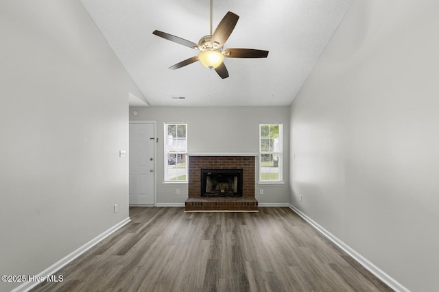 219 Live Oak Ct, Midway Park, NC 28544 - unfurnished living room featuring wood finished floors, lofted ceiling, baseboards, a ceiling fan, and a fireplace
