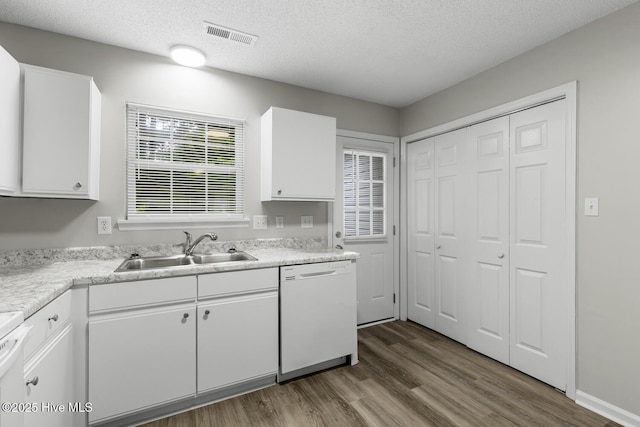 219 Live Oak Ct, Midway Park, NC 28544 - kitchen featuring white dishwasher, a sink, wood finished floors, white cabinets, and light countertops