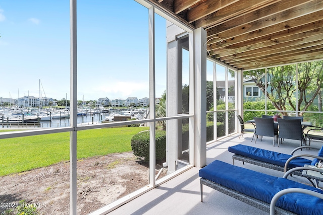 2555 St James Dr SE Unit 102, Southport, NC 28461 - sunroom / solarium with a water view and outdoor dining space