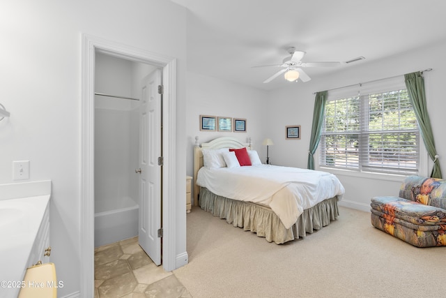 2555 St James Dr SE Unit 102, Southport, NC 28461 - bedroom featuring light colored carpet, baseboards, a ceiling fan, a walk in closet, and a closet