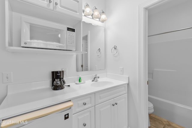 2555 St James Dr SE Unit 102, Southport, NC 28461 - full bath with vanity, toilet, and shower / bathtub combination