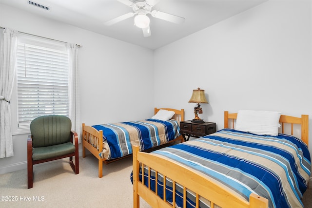2555 St James Dr SE Unit 102, Southport, NC 28461 - bedroom with carpet flooring, multiple windows, and a ceiling fan