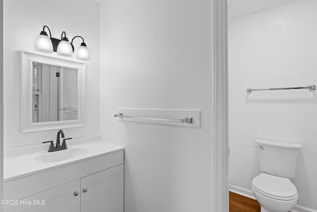 515 Brynn Marr Rd, Jacksonville, NC 28546 - bathroom with vanity, toilet, baseboards, and wood finished floors