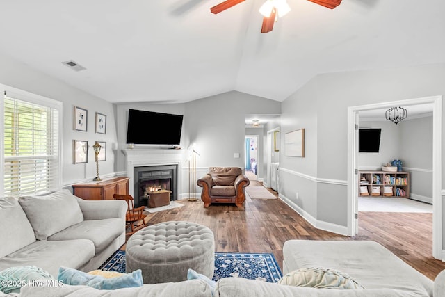 912 Morganser Dr, Swansboro, NC 28584 - living room with ceiling fan, wood finished floors, lofted ceiling, a fireplace with flush hearth, and baseboards