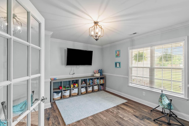 912 Morganser Dr, Swansboro, NC 28584 - living area with ornamental molding, wood finished floors, a chandelier, and baseboards