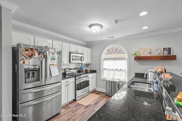 912 Morganser Dr, Swansboro, NC 28584 - kitchen with appliances with stainless steel finishes, a sink, white cabinetry, ornamental molding, and open shelves