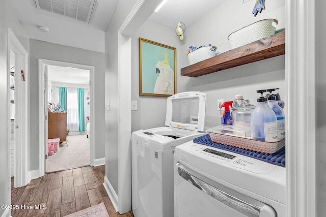 912 Morganser Dr, Swansboro, NC 28584 - laundry area with wood finished floors, washing machine and clothes dryer, and baseboards