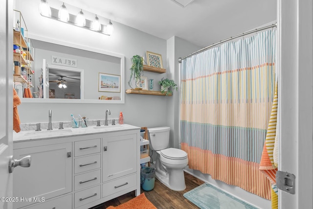 912 Morganser Dr, Swansboro, NC 28584 - bathroom with toilet, wood finished floors, double vanity, ceiling fan, and a shower with shower curtain