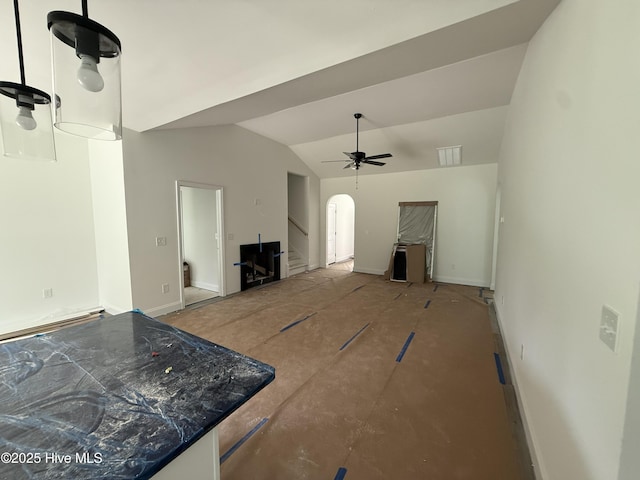 255 Atkins Rd, Cameron, NC 28326 - unfurnished living room with baseboards, stairs, lofted ceiling, arched walkways, and a ceiling fan