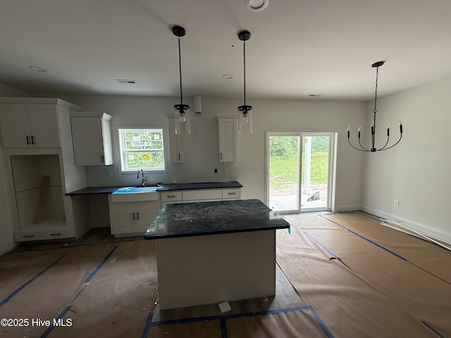 255 Atkins Rd, Cameron, NC 28326 - kitchen featuring a sink, white cabinetry, dark countertops, a chandelier, and decorative light fixtures