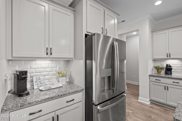 106 Josephs Pt, West End, NC 27376 - kitchen featuring stainless steel fridge with ice dispenser, ornamental molding, backsplash, light stone countertops, and light wood-type flooring