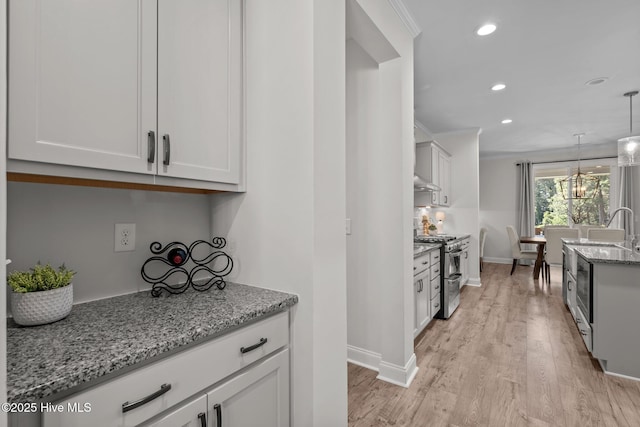 106 Josephs Pt, West End, NC 27376 - kitchen featuring double oven range, recessed lighting, light stone countertops, light wood-type flooring, and white cabinets