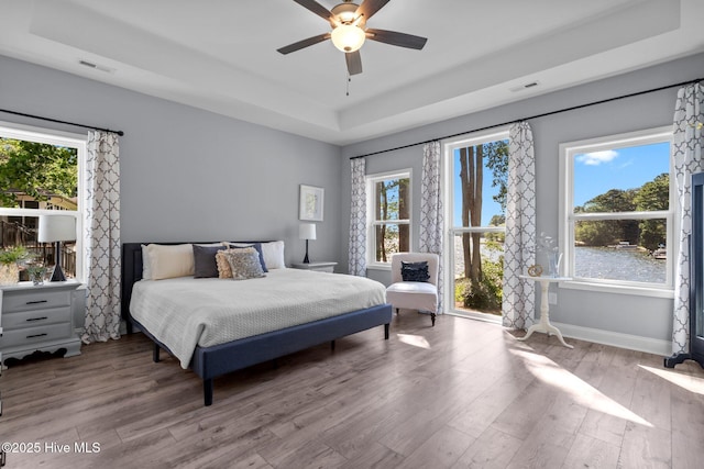 106 Josephs Pt, West End, NC 27376 - bedroom featuring a tray ceiling, wood finished floors, baseboards, and ceiling fan