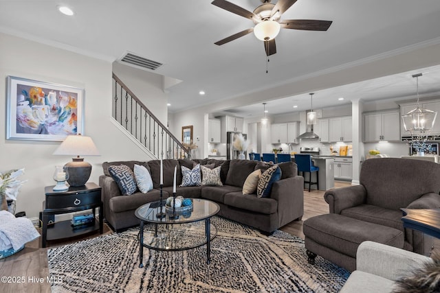 106 Josephs Pt, West End, NC 27376 - living room with light wood-type flooring, a ceiling fan, stairs, crown molding, and recessed lighting