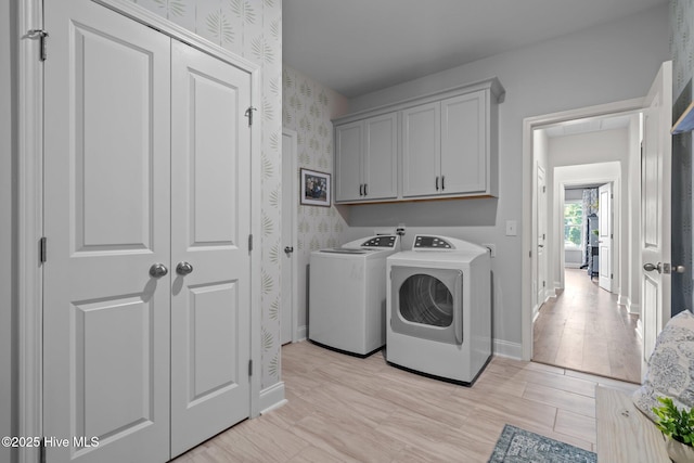 106 Josephs Pt, West End, NC 27376 - laundry room featuring washing machine and dryer, baseboards, wallpapered walls, light wood finished floors, and cabinet space