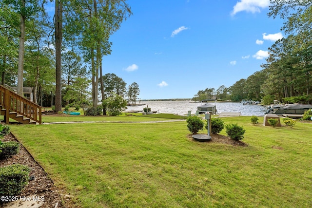 106 Josephs Pt, West End, NC 27376 - view of grassy yard with a water view and stairs