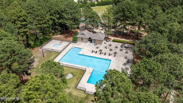 106 Josephs Pt, West End, NC 27376 - bird's eye view of a pool and a heavily wooded area
