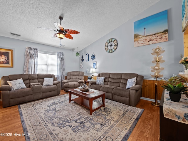 500 Nutfield Dr, Hubert, NC 28539 - living room with wood finished floors, a textured ceiling, a ceiling fan, and a wainscoted wall