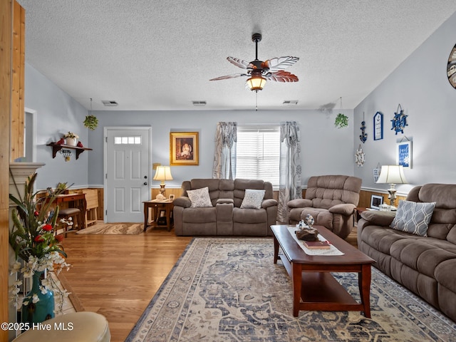 500 Nutfield Dr, Hubert, NC 28539 - living area with wood finished floors, ceiling fan, a textured ceiling, and wainscoting