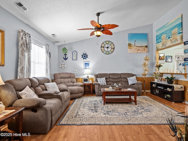 500 Nutfield Dr, Hubert, NC 28539 - living room featuring vaulted ceiling, wood finished floors, a textured ceiling, and a ceiling fan