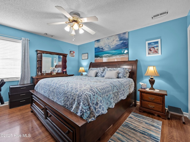 500 Nutfield Dr, Hubert, NC 28539 - bedroom featuring wood finished floors, a textured ceiling, ceiling fan, and baseboards