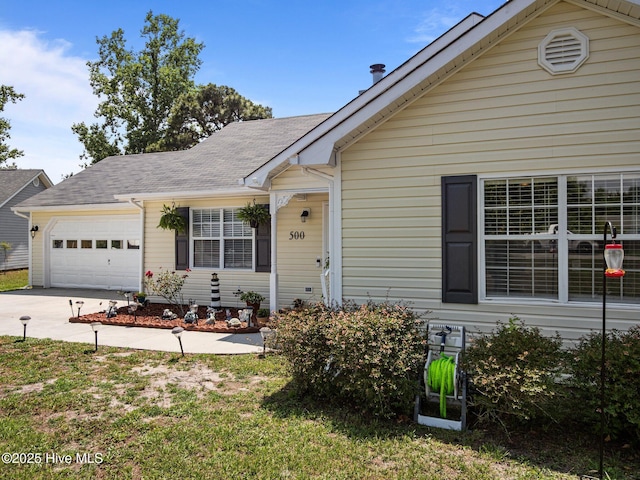500 Nutfield Dr, Hubert, NC 28539 - view of front of property with an attached garage, driveway, and roof with shingles