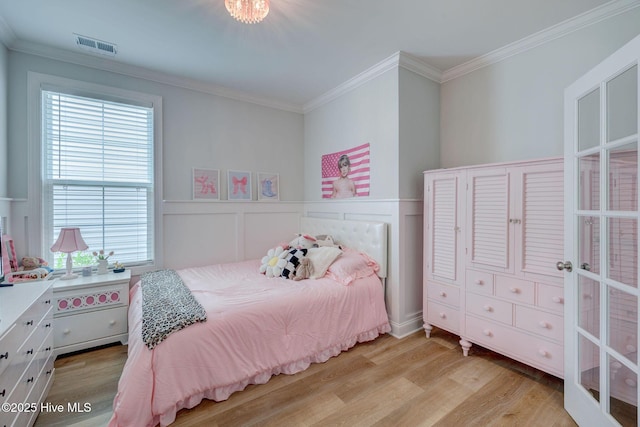 5920 Appomattox Dr, Wilmington, NC 28409 - bedroom with crown molding, wood finished floors, multiple windows, and wainscoting