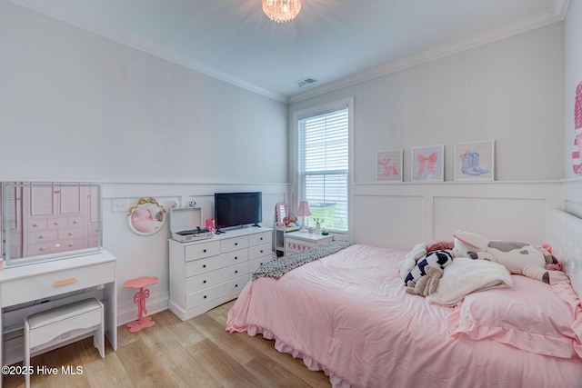 5920 Appomattox Dr, Wilmington, NC 28409 - bedroom with light wood-style flooring, crown molding, a wainscoted wall, and a decorative wall