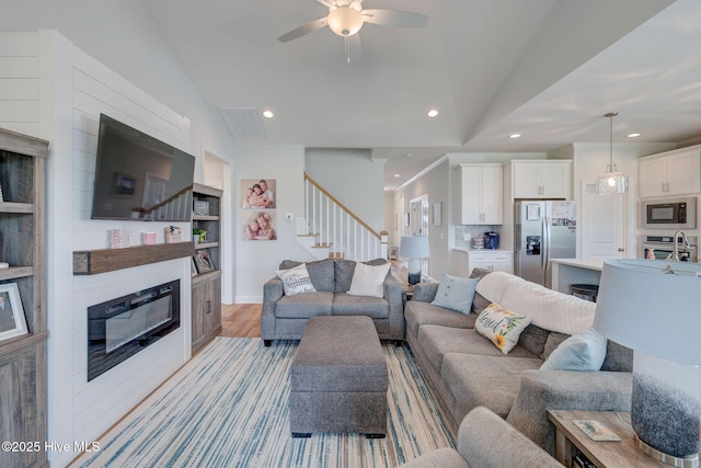5920 Appomattox Dr, Wilmington, NC 28409 - living room with stairway, recessed lighting, ceiling fan, light wood-style flooring, and vaulted ceiling