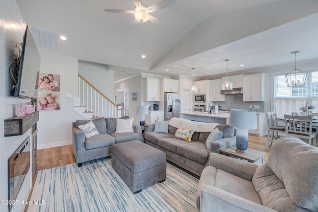 5920 Appomattox Dr, Wilmington, NC 28409 - living area featuring light wood-style flooring, stairway, recessed lighting, vaulted ceiling, and ceiling fan