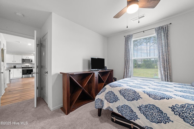 3402 Woodwind Ct, Kinston, NC 28504 - bedroom with light carpet, a ceiling fan, and baseboards