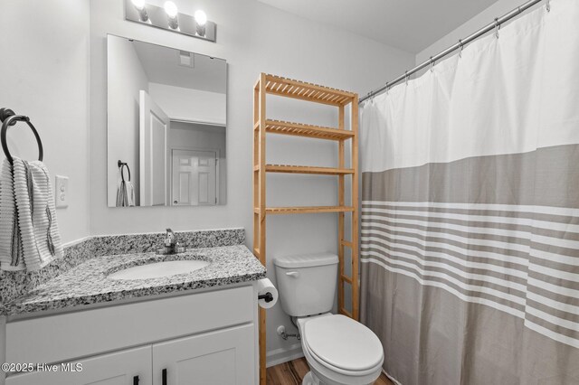 3402 Woodwind Ct, Kinston, NC 28504 - bathroom featuring vanity, toilet, wood finished floors, and a shower with shower curtain