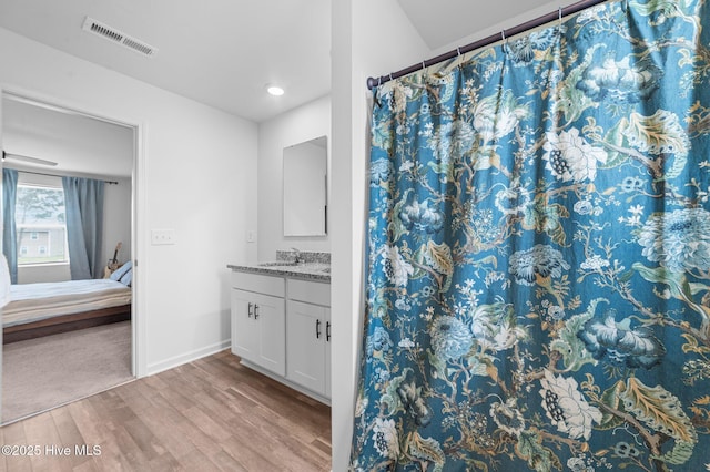 3402 Woodwind Ct, Kinston, NC 28504 - ensuite bathroom with wood finished floors, vanity, baseboards, a shower with curtain, and recessed lighting