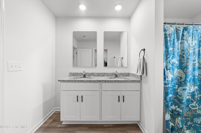 3402 Woodwind Ct, Kinston, NC 28504 - bathroom featuring double vanity, wood finished floors, baseboards, and a shower with curtain
