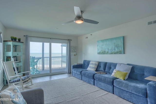 1896 New River Inlet Rd Unit 1212, North Topsail Beach, NC 28460 - living room featuring wood finished floors, ceiling fan, and a water view