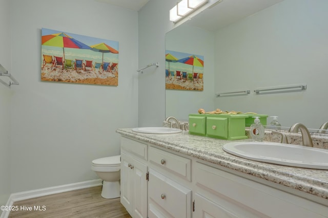 1896 New River Inlet Rd Unit 1212, North Topsail Beach, NC 28460 - bathroom featuring double vanity, toilet, wood finished floors, and baseboards