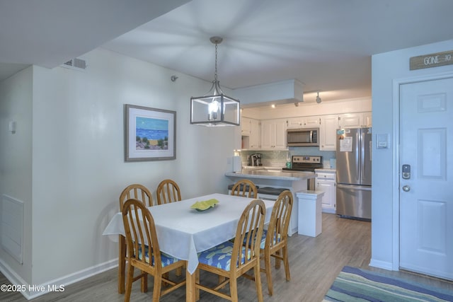 1896 New River Inlet Rd Unit 1212, North Topsail Beach, NC 28460 - dining space with wood finished floors and baseboards