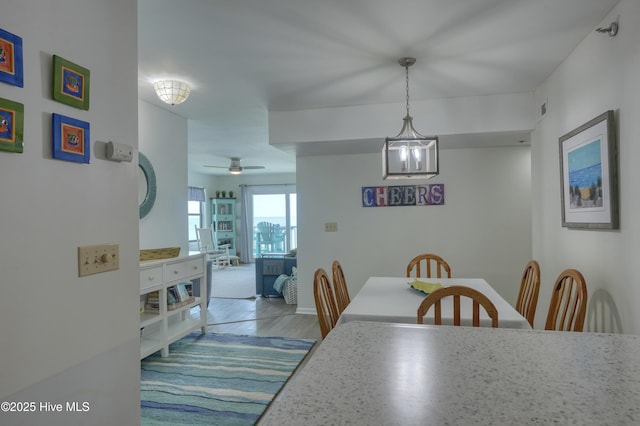 1896 New River Inlet Rd Unit 1212, North Topsail Beach, NC 28460 - dining room featuring a chandelier, ceiling fan, and wood finished floors