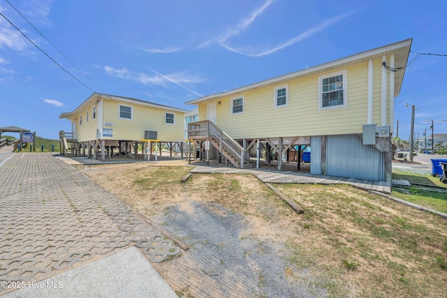 1020 Carolina Beach Ave N, Carolina Beach, NC 28428 - rear view of property with stairs and a carport