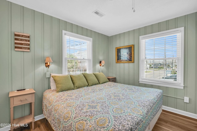 1020 Carolina Beach Ave N, Carolina Beach, NC 28428 - bedroom with baseboards and dark wood-type flooring