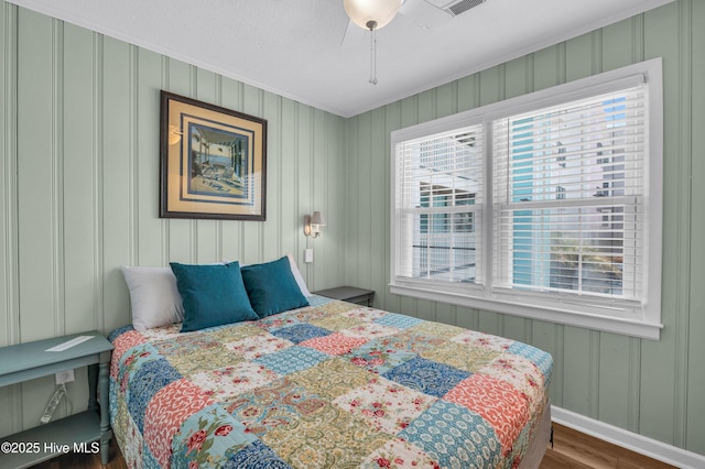 1020 Carolina Beach Ave N, Carolina Beach, NC 28428 - bedroom with ornamental molding, wood finished floors, and a decorative wall