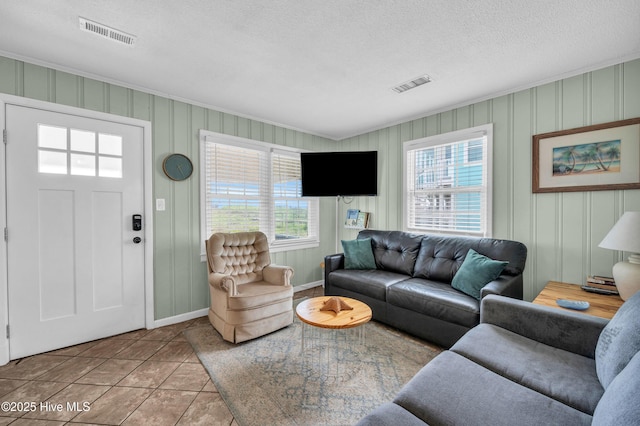 1020 Carolina Beach Ave N, Carolina Beach, NC 28428 - living room with tile patterned floors, a textured ceiling, and ornamental molding